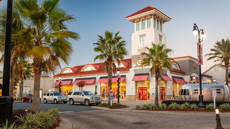 Open-air shopping center with palm trees and storefronts at Destin Commons in Destin, Florida.