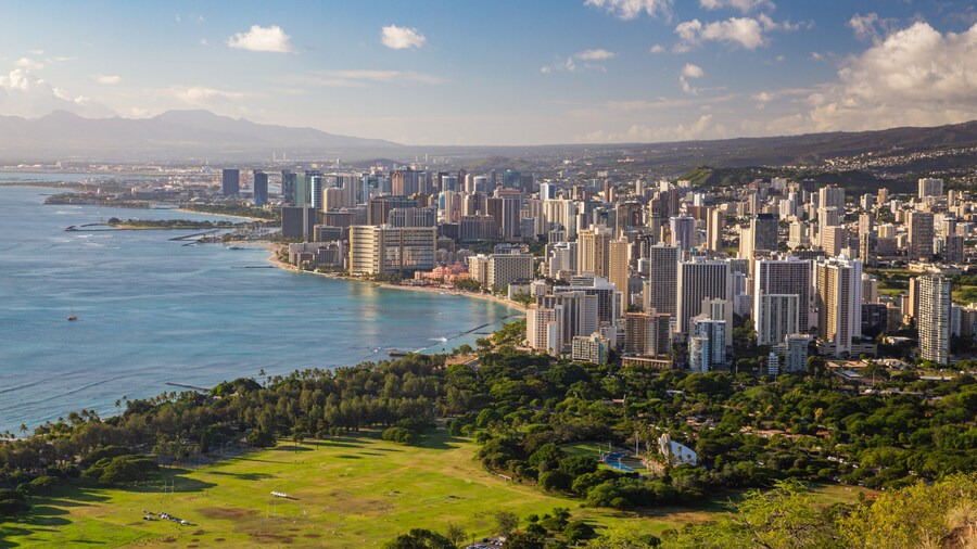 Panoramic view of Diamond Head crater and Honolulu cityscape under a clear sky.