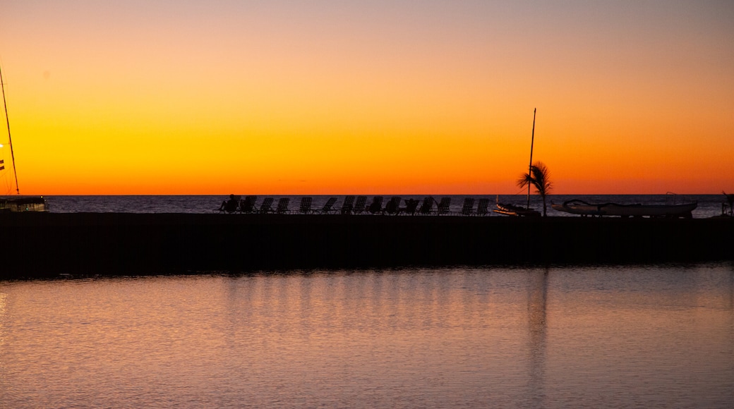 Waikōloa Beach which includes a sunset and general coastal views