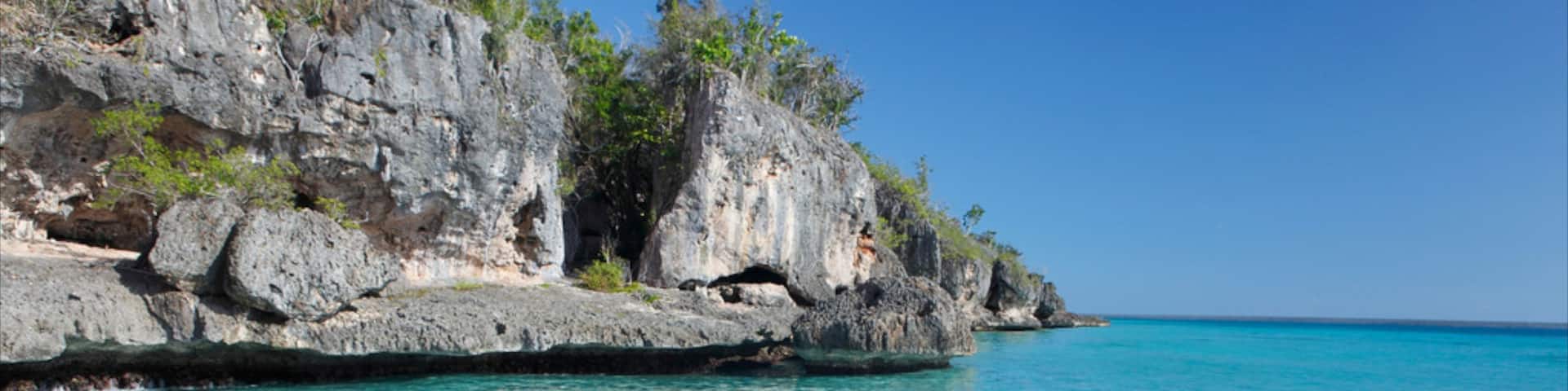 Bayahibe Beach which includes swimming, rugged coastline and general coastal views