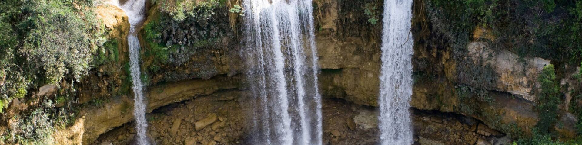Los Haitises National Park featuring a lake or waterhole and a cascade