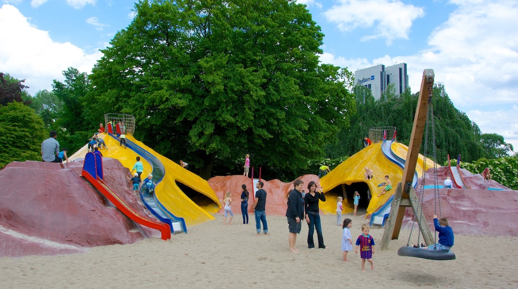 Botanical Gardens which includes a garden and a playground as well as a large group of people