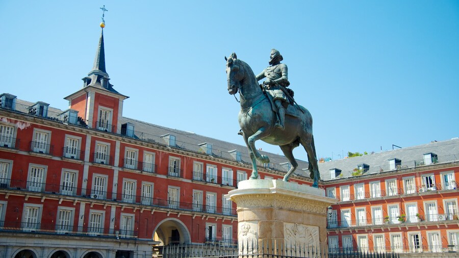 Central statue and elegant architecture of Plaza Mayor in Madrid.