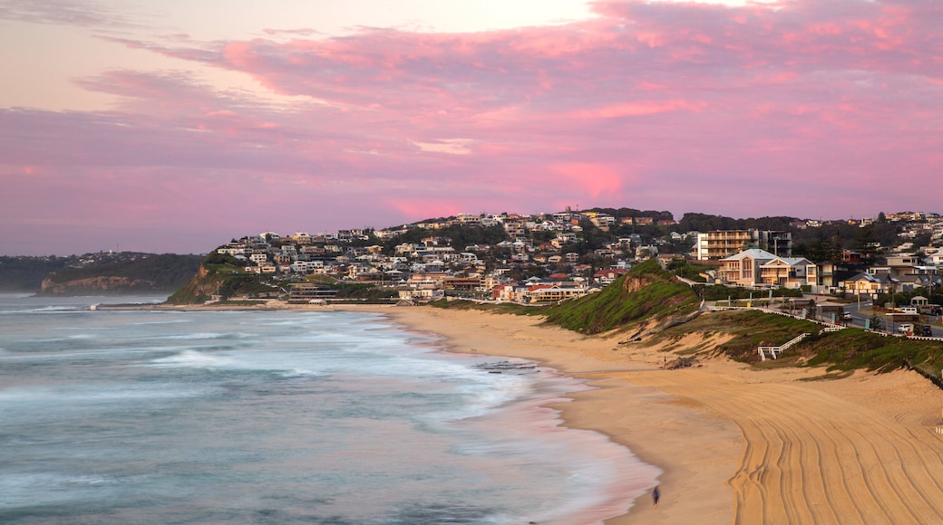 Bar Beach featuring a sandy beach, a coastal town and a sunset