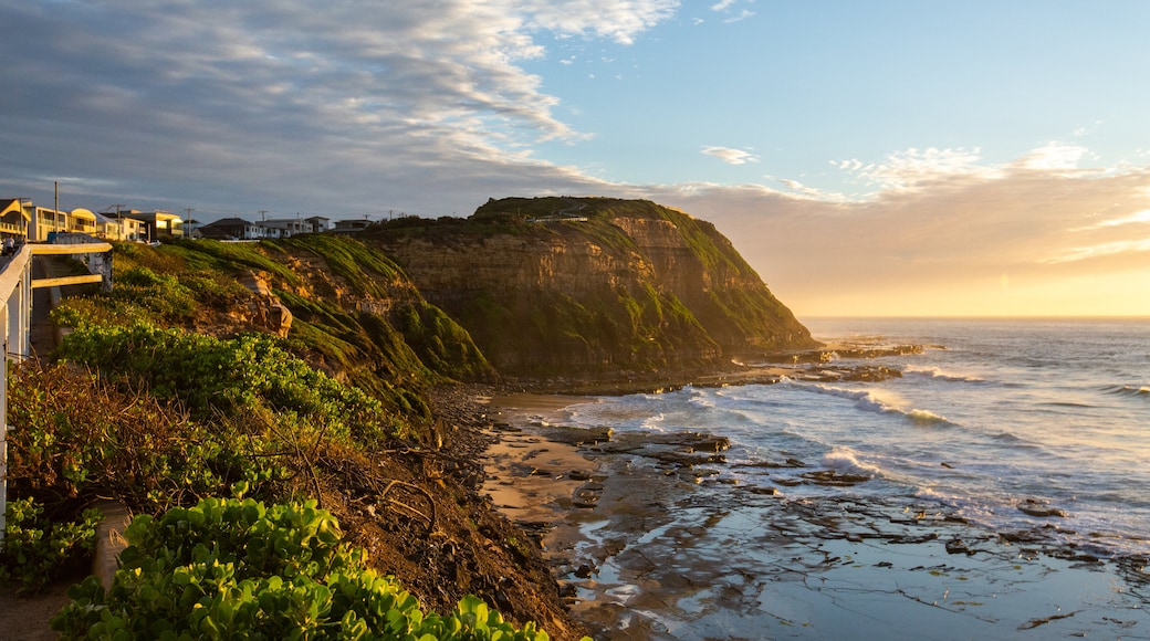 Bar Beach which includes rocky coastline, a sunset and general coastal views