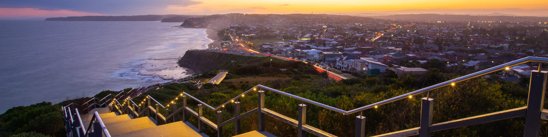 ANZAC Memorial Bridge which includes general coastal views, a sunset and a coastal town