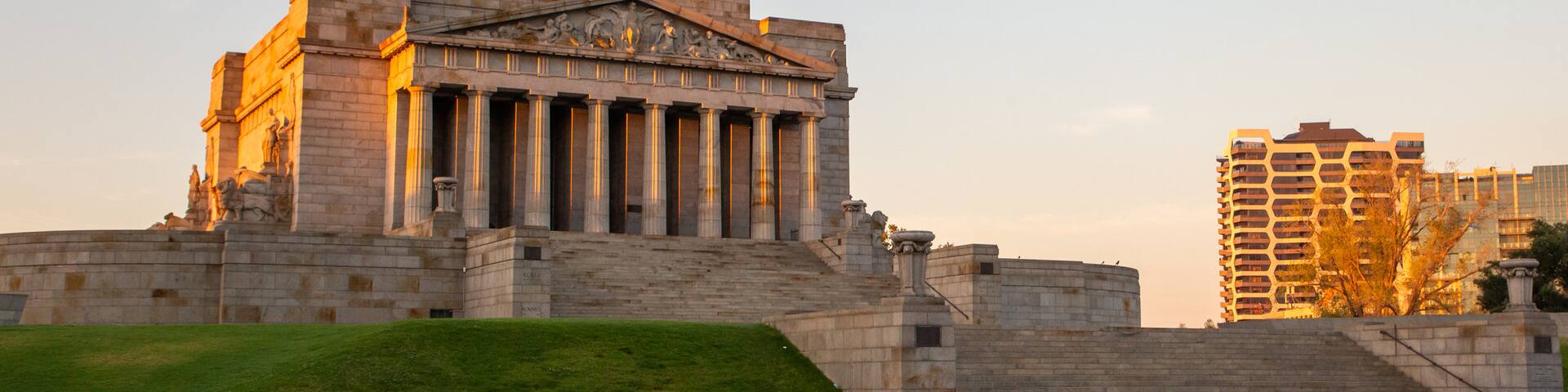 Shrine of Remembrance which includes heritage architecture and a sunset