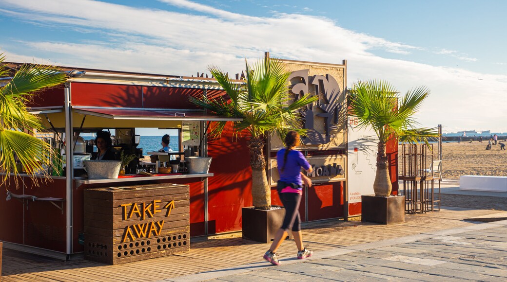 Bogatell Beach which includes a beach bar and signage as well as an individual femail