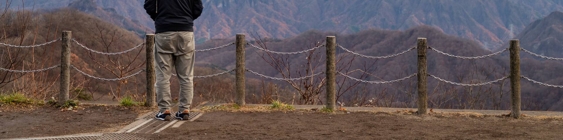 Usui Pass Observation Platform featuring views and tranquil scenes as well as an individual male