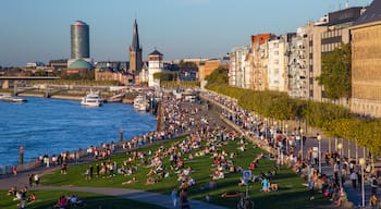 Düsseldorf Old Town featuring a city and a river or creek as well as a large group of people