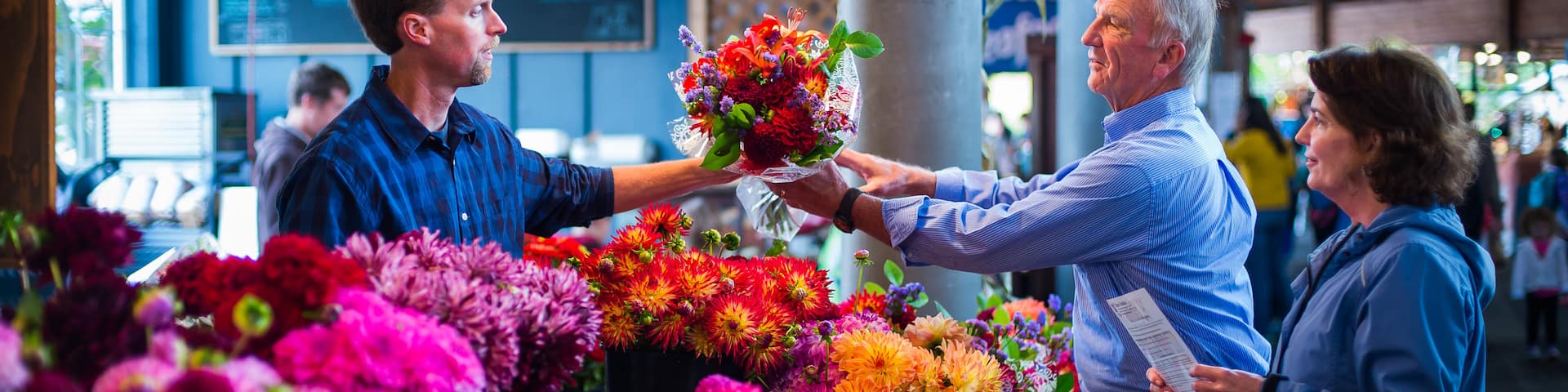 Olympia Farmers Market showing markets and flowers as well as a couple