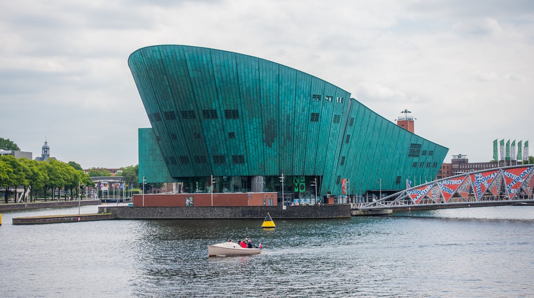 Old Town Amsterdam which includes boating, modern architecture and a river or creek