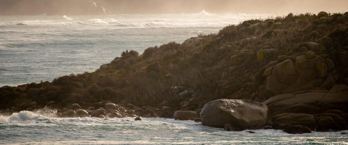The Bluff featuring rugged coastline, general coastal views and a sunset