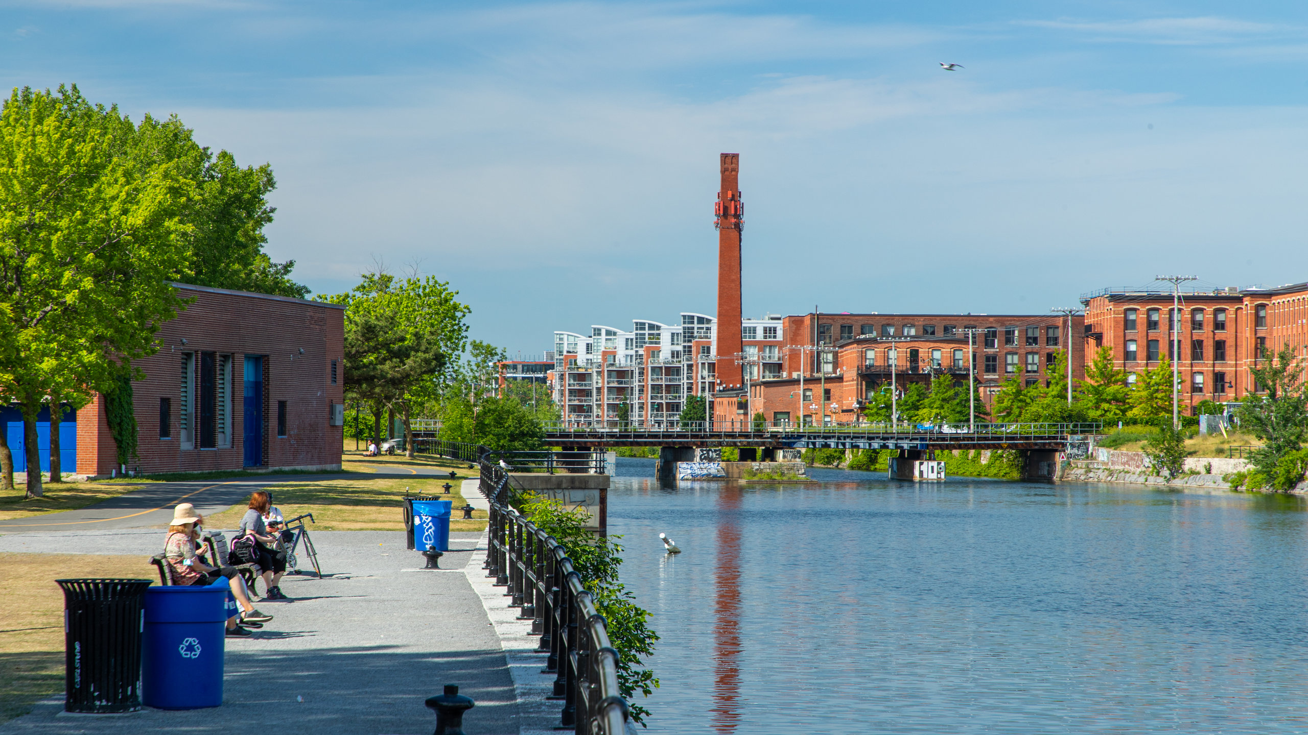 Scenic view of Lachine Canal in Montreal with lush paths and tranquil waters.