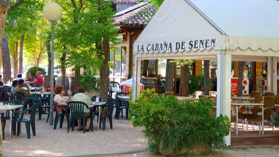 Madrid showing signage, a bar and outdoor eating