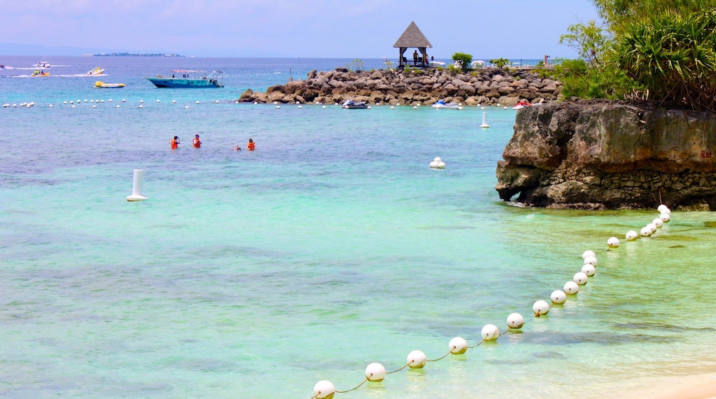 Cebu featuring a beach, tropical scenes and rocky coastline