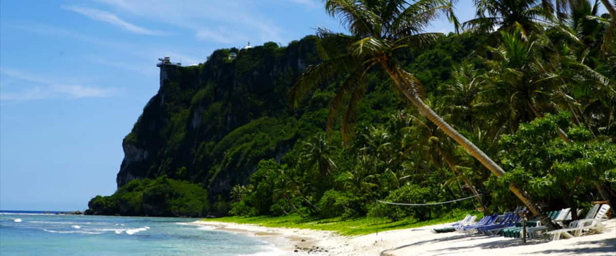 Tumon Beach showing a gorge or canyon, a sandy beach and tropical scenes