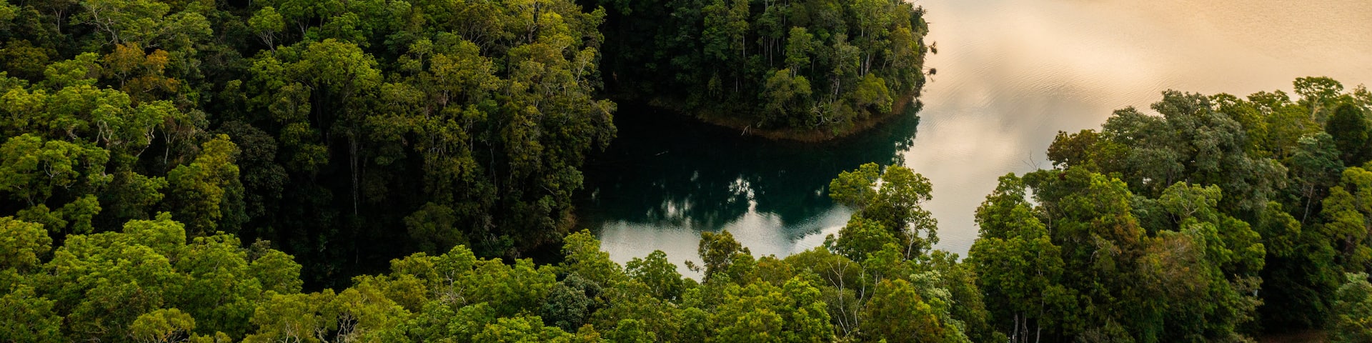 Lake Eacham featuring tranquil scenes, landscape views and a sunset