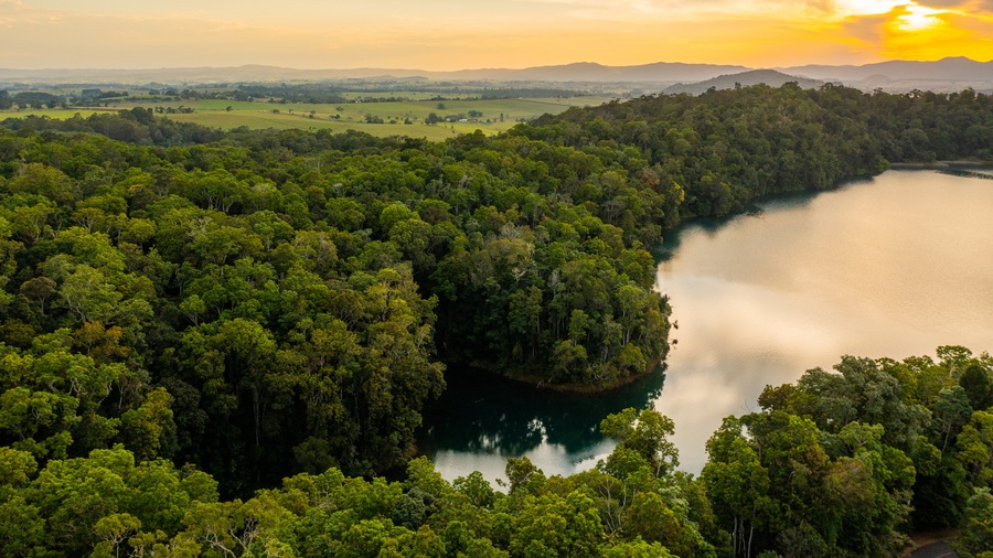 Lake Eacham featuring tranquil scenes, landscape views and a sunset