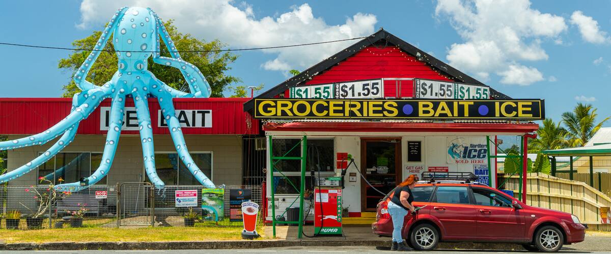 Babinda featuring signage and a small town or village as well as an individual femail