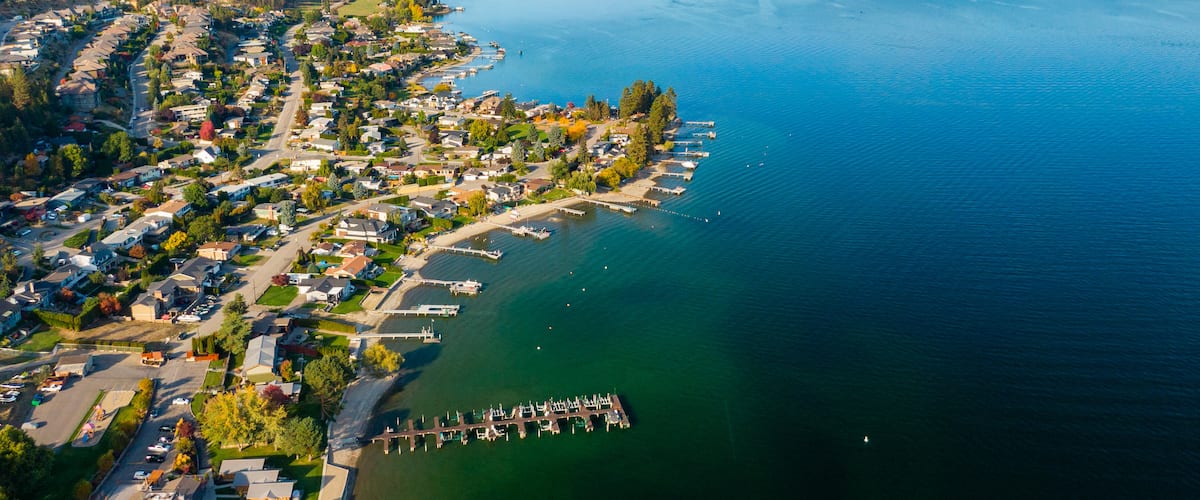Okanagan Lake which includes landscape views, a small town or village and a lake or waterhole
