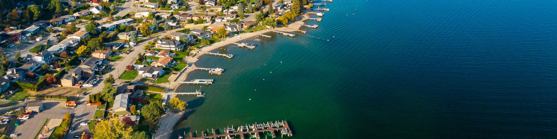 Okanagan Lake which includes landscape views, a small town or village and a lake or waterhole
