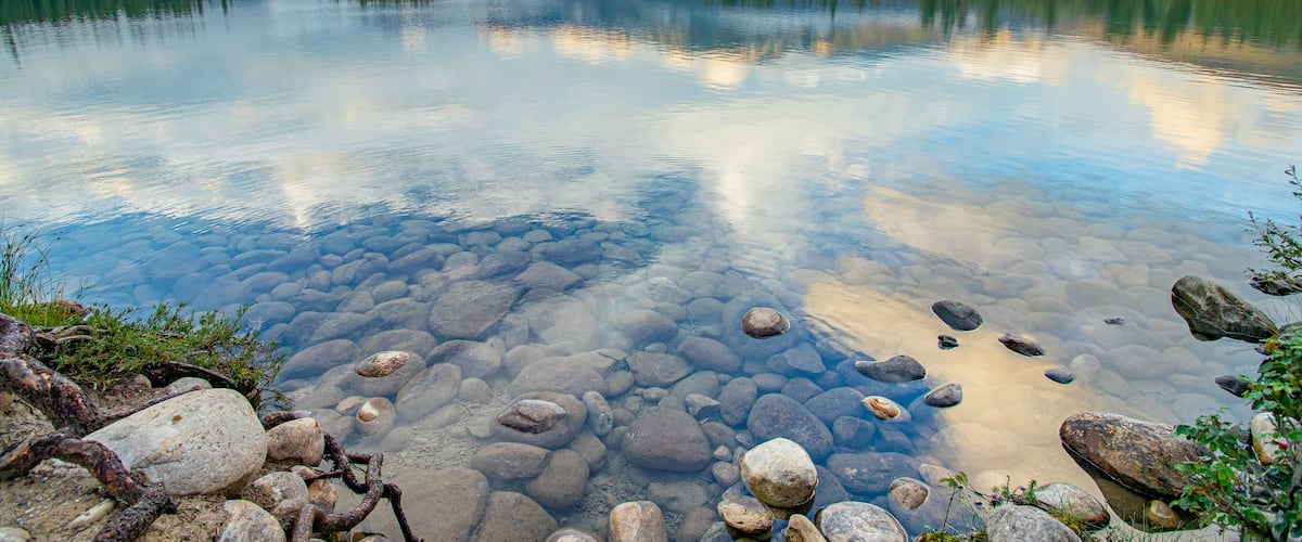 Lac Beauvert featuring a sunset and a lake or waterhole