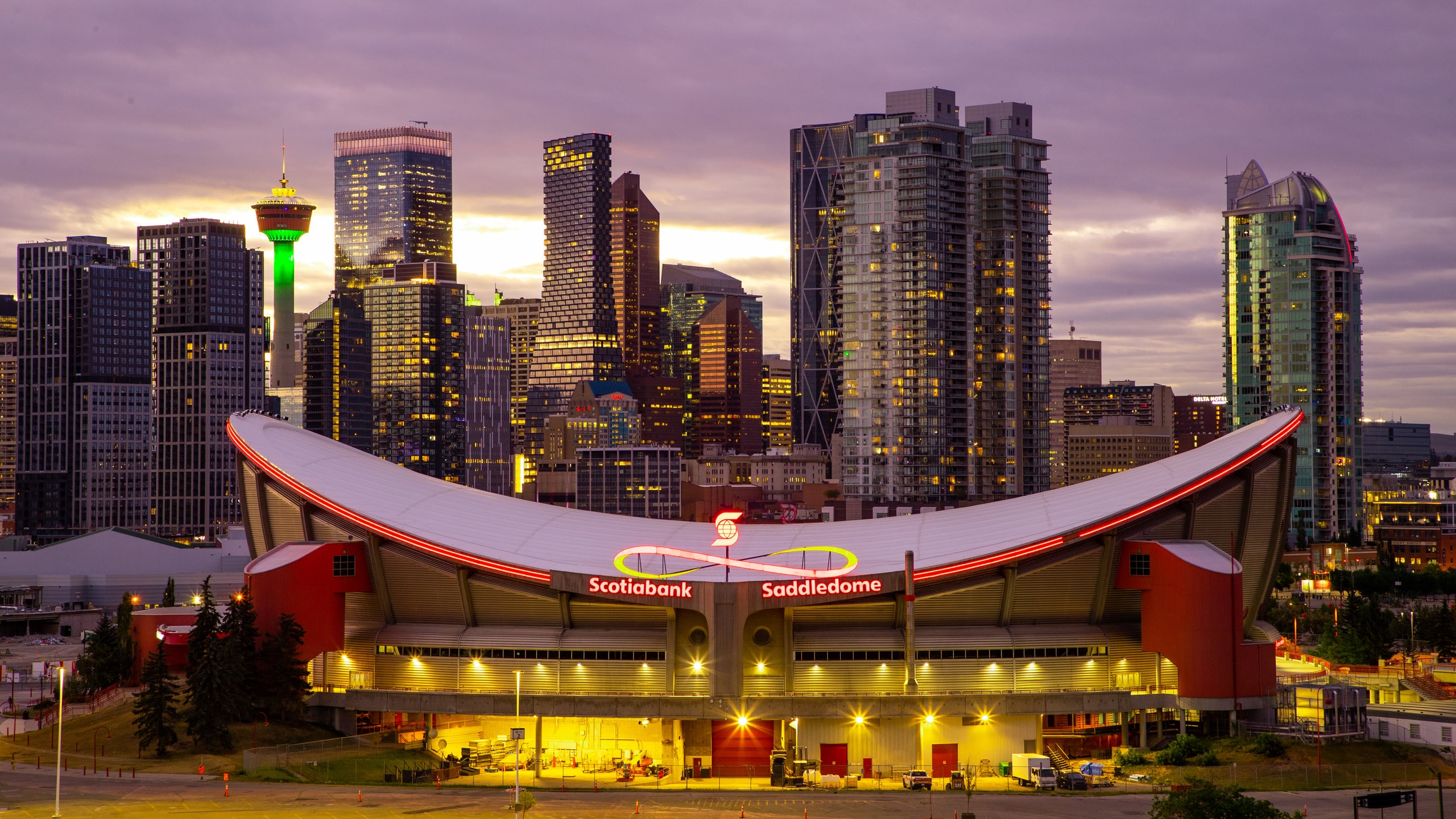 Scotiabank Saddledome which includes a city, a sunset and modern architecture