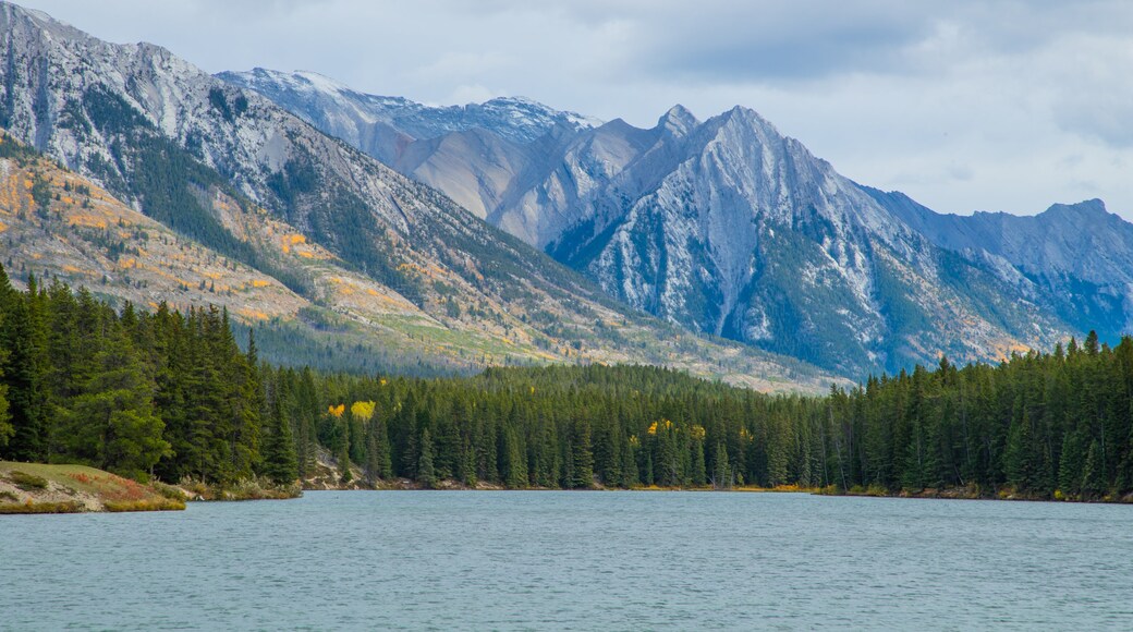 Minnewanka Loop / Lake Johnson featuring mountains and a lake or waterhole