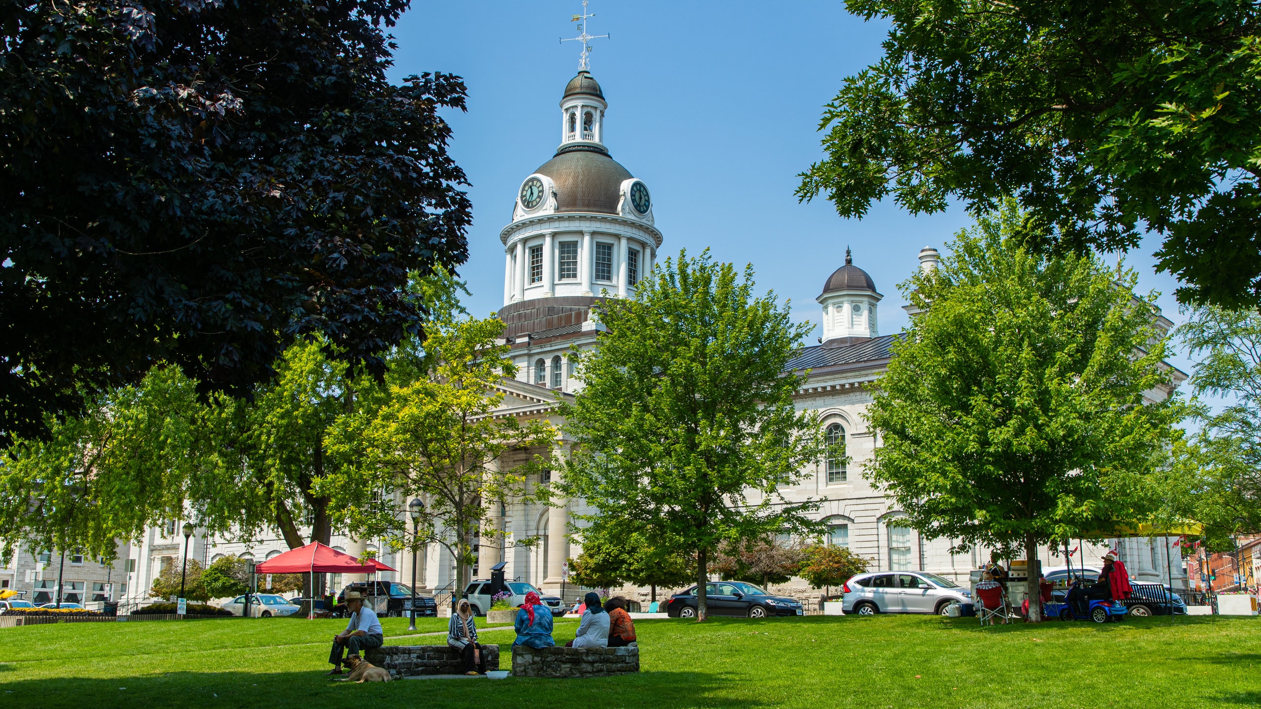 Kingston Waterfront which includes a park and heritage architecture as well as a small group of people