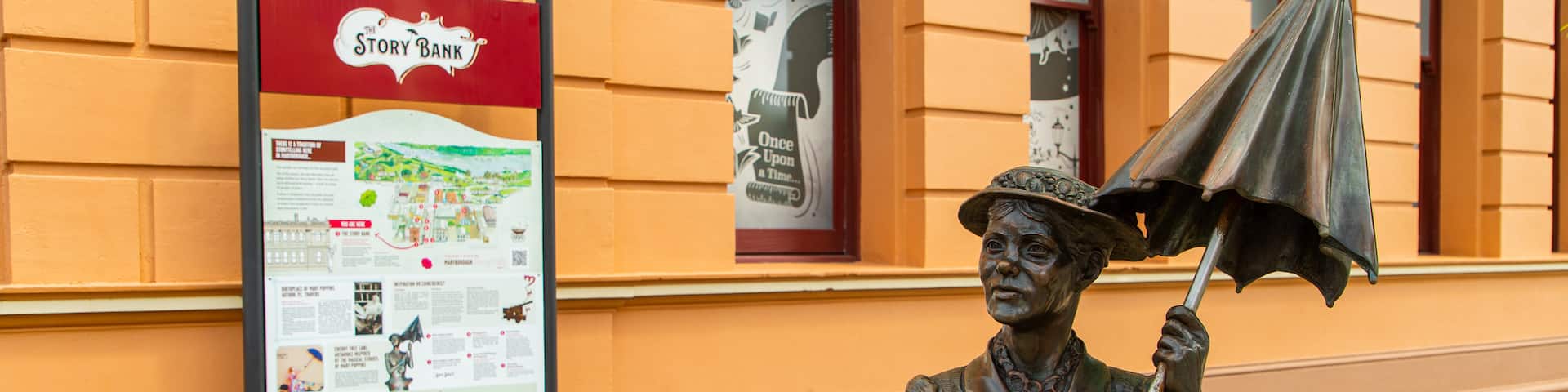 Mary Poppins Statue featuring signage and a statue or sculpture