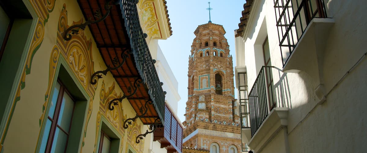 Poble Espanyol which includes a church or cathedral, heritage architecture and a city