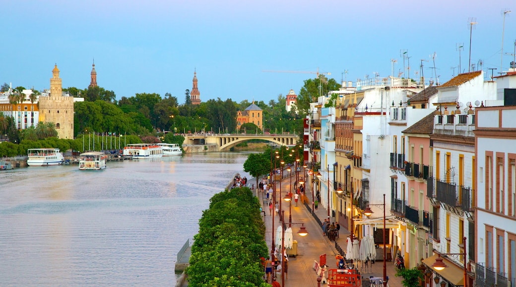 Triana Bridge showing a river or creek, a city and street scenes