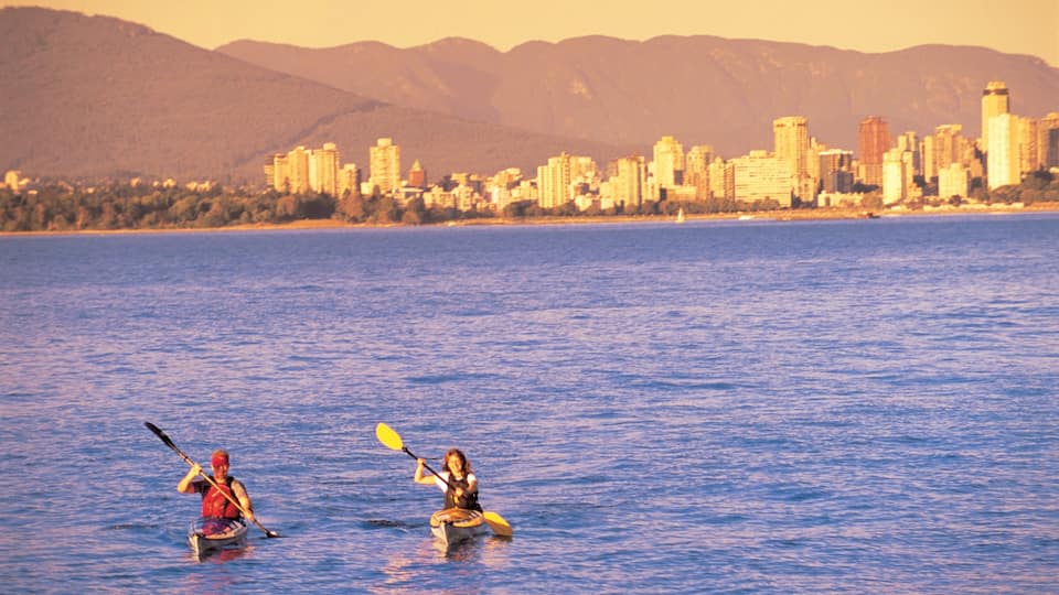 Jericho Beach which includes a sunset, general coastal views and kayaking or canoeing