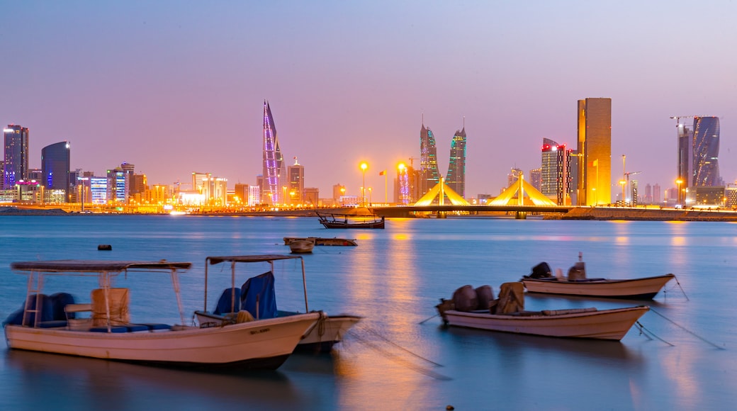 Manama showing a city, a bay or harbor and night scenes