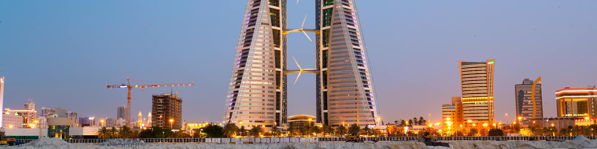 Bahrain World Trade Center which includes a city, modern architecture and night scenes