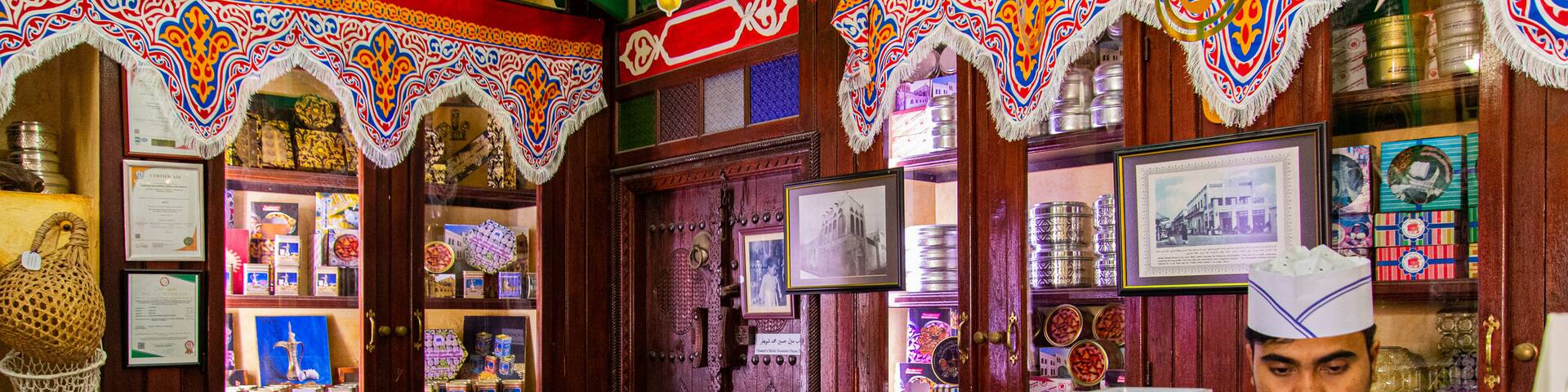 Muharraq Souq featuring interior views and food as well as an individual male