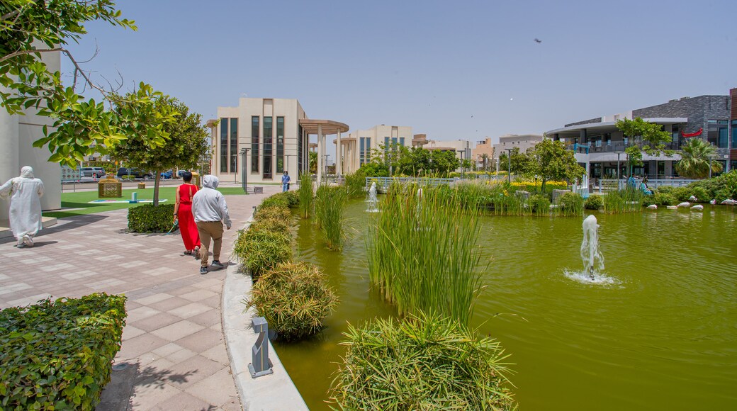 Zallaq which includes a fountain, a pond and street scenes