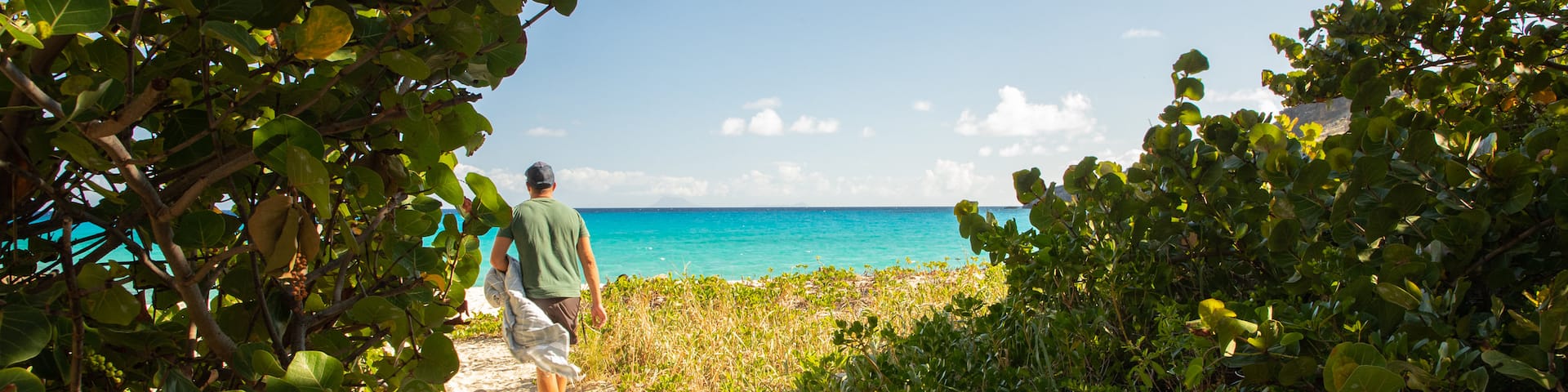 Gouverneur Beach featuring general coastal views and a beach as well as an individual male