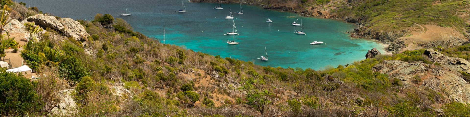 Colombier Beach which includes landscape views, rugged coastline and island views