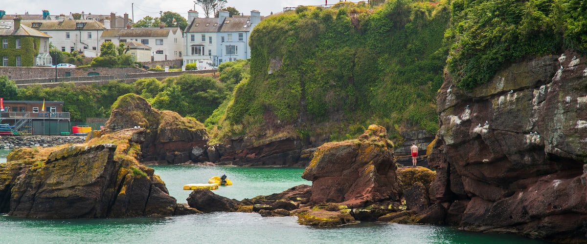 Dunmore East which includes rocky coastline and general coastal views