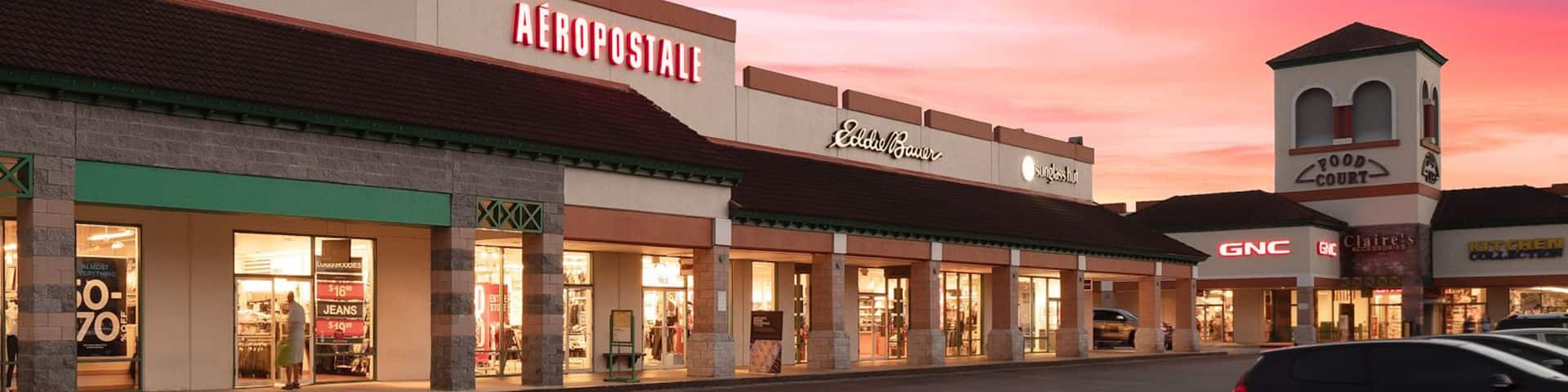 St. Augustine Premium Outlets which includes signage, shopping and a sunset