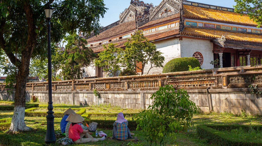 Imperial City featuring heritage architecture and a park as well as a small group of people