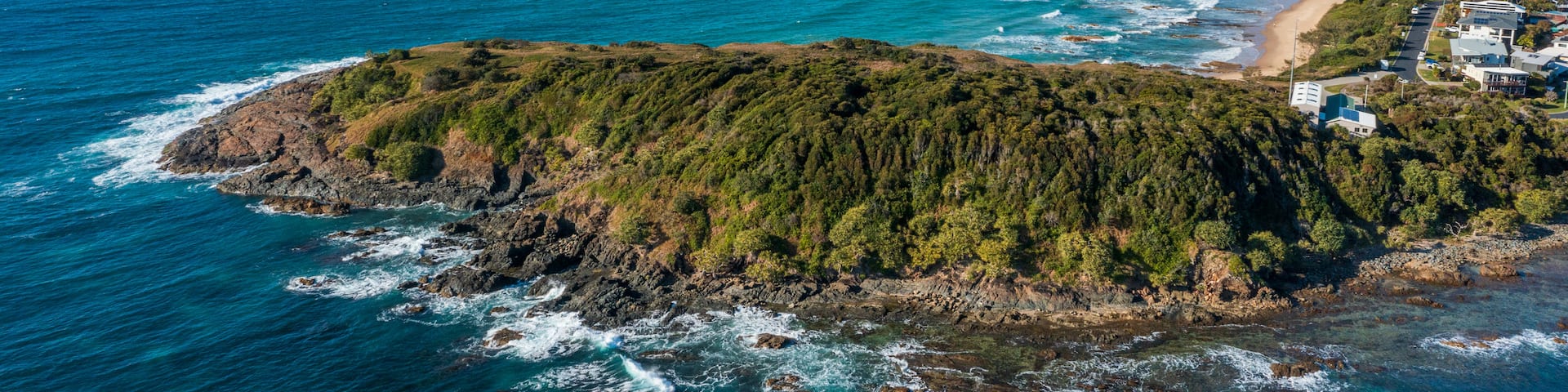 Woolgoolga featuring general coastal views, rugged coastline and landscape views