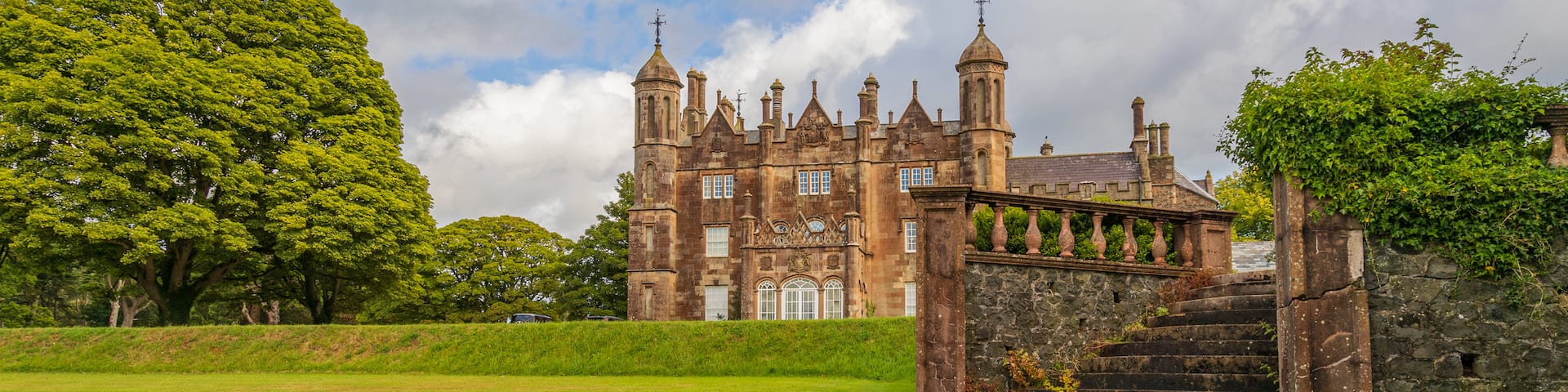 Glenarm Castle showing a park, heritage architecture and chateau or palace