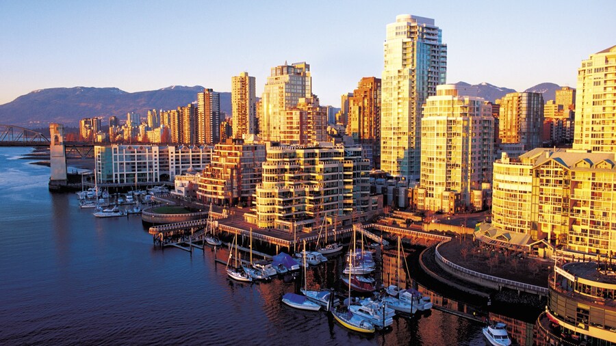 Waterfront view of False Creek with Vancouver skyline and marina in the background.