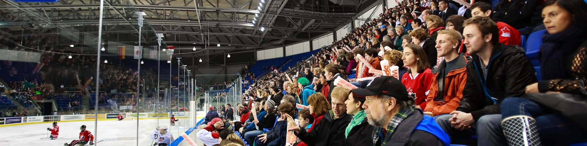 Doug Mitchell Thunderbird Sports Centre featuring a sporting event and interior views as well as a large group of people