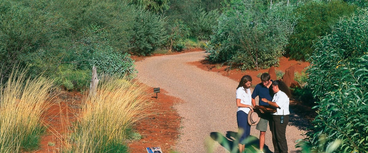 Alice Springs Desert Park which includes a garden and desert views as well as a small group of people