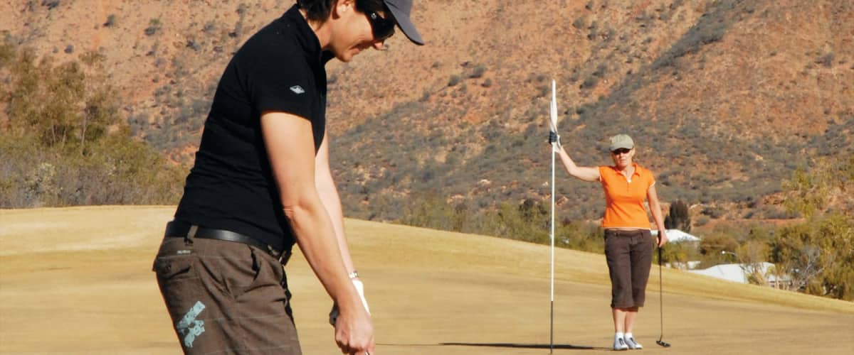 Alice Springs showing tranquil scenes and golf as well as a couple