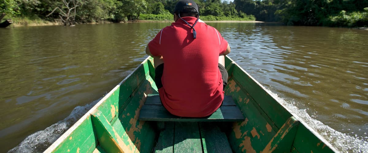Gunung Mulu National Park showing a river or creek and boating as well as an individual male